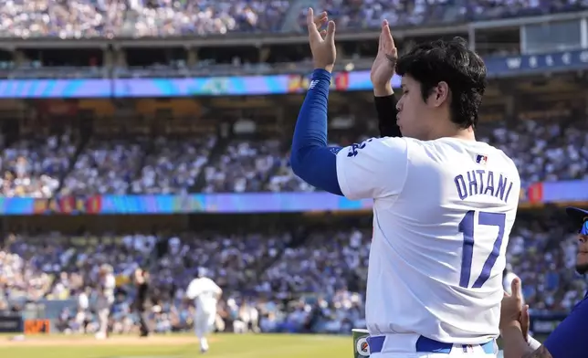 Los Angeles Dodgers' Shohei Ohtani celebrates during the sixth inning in Game 2 of a baseball NL Championship Series against the New York Mets, Monday, Oct. 14, 2024, in Los Angeles. (AP Photo/Gregory Bull)