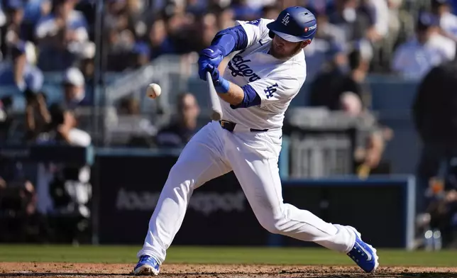 Los Angeles Dodgers' Max Muncy connects for a solo home run against the New York Mets during the fifth inning in Game 2 of a baseball NL Championship Series, Monday, Oct. 14, 2024, in Los Angeles. (AP Photo/Gregory Bull)