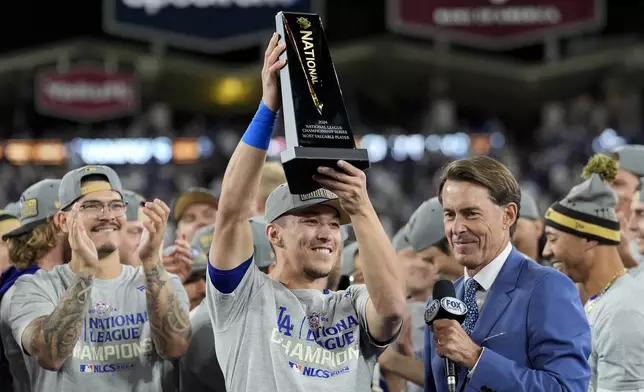 Los Angeles Dodgers' Tommy Edman celebrates after their win against the New York Mets in Game 6 of a baseball NL Championship Series, Sunday, Oct. 20, 2024, in Los Angeles. The Dodgers will face the New York Yankees in the World. (AP Photo/Ashley Landis)