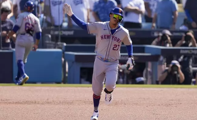 New York Mets' Mark Vientos celebrates as he rounds the bases after his grand slam home run against the Los Angeles Dodgers during the second inning in Game 2 of a baseball NL Championship Series, Monday, Oct. 14, 2024, in Los Angeles. (AP Photo/Mark J. Terrill)