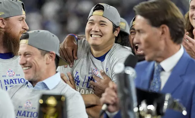 Los Angeles Dodgers' Shohei Ohtani celebrates after their win against the New York Mets in Game 6 of a baseball NL Championship Series, Sunday, Oct. 20, 2024, in Los Angeles. The Dodgers will face the New York Yankees in the World. (AP Photo/Ashley Landis)