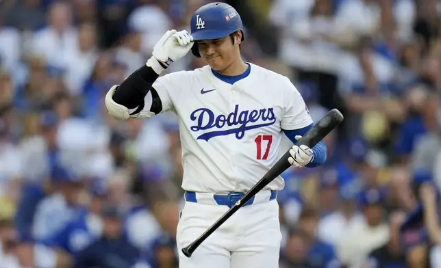 Los Angeles Dodgers' Shohei Ohtani bats against the New York Mets during the first inning in Game 6 of a baseball NL Championship Series, Sunday, Oct. 20, 2024, in Los Angeles. (AP Photo/Julio Cortez)