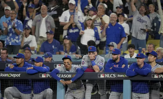 New York Mets react to their loss against the Los Angeles Dodgers in Game 6 of a baseball NL Championship Series, Sunday, Oct. 20, 2024, in Los Angeles. The Dodgers will face the New York Yankees in the World Series. (AP Photo/Ashley Landis)