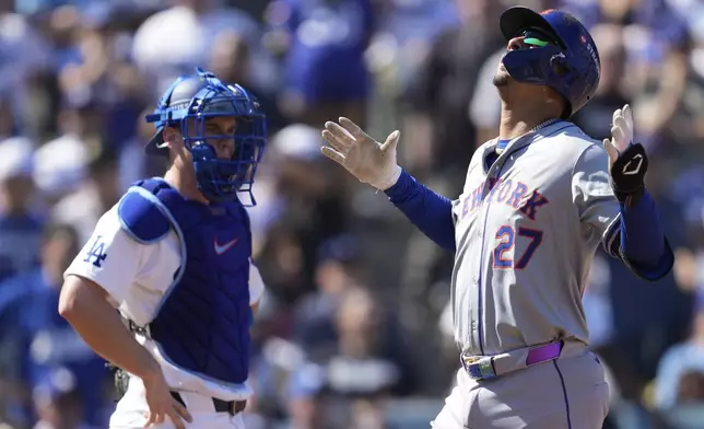 New York Mets' Mark Vientos, right, celebrates after his grand slam home run against the Los Angeles Dodgers during the second inning in Game 2 of a baseball NL Championship Series, Monday, Oct. 14, 2024, in Los Angeles. (AP Photo/Ashley Landis)