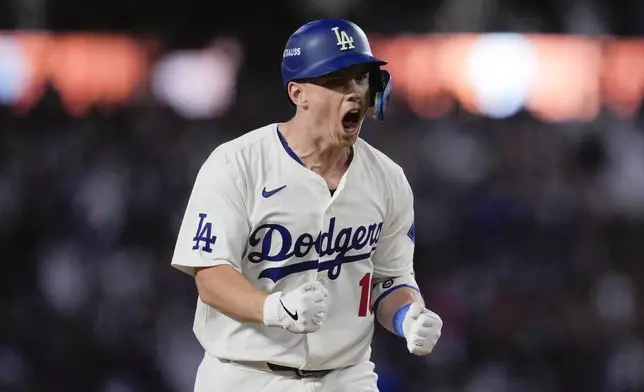 Los Angeles Dodgers' Will Smith celebrates a two-run home run against the New York Mets during the third inning in Game 6 of a baseball NL Championship Series, Sunday, Oct. 20, 2024, in Los Angeles.(AP Photo/Ashley Landis)