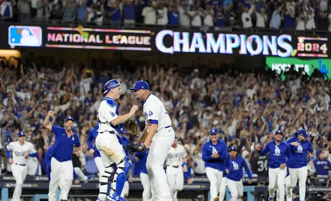 Los Angeles Dodgers pitcher Blake Treinen and catcher Will Smith celebrate their win against the New York Mets in Game 6 of a baseball NL Championship Series, Sunday, Oct. 20, 2024, in Los Angeles. The Dodgers will face the New York Yankees in the World Series. (AP Photo/Julio Cortez)