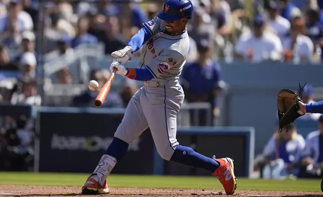 New York Mets' Francisco Lindor connects for a solo home run against the Los Angeles Dodgers during the first inning in Game 2 of a baseball NL Championship Series, Monday, Oct. 14, 2024, in Los Angeles. (AP Photo/Gregory Bull)