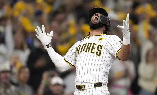 San Diego Padres' Fernando Tatis Jr. celebrates after hitting a two-run home run during the second inning in Game 3 of a baseball NL Division Series against the Los Angeles Dodgers, Tuesday, Oct. 8, 2024, in San Diego. (AP Photo/Ashley Landis)