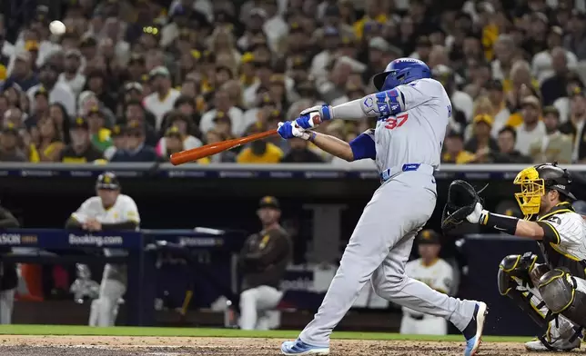 Los Angeles Dodgers' Teoscar Hernández connects for a grand slam during the third inning in Game 3 of a baseball NL Division Series against the San Diego Padres, Tuesday, Oct. 8, 2024, in San Diego. (AP Photo/Gregory Bull)