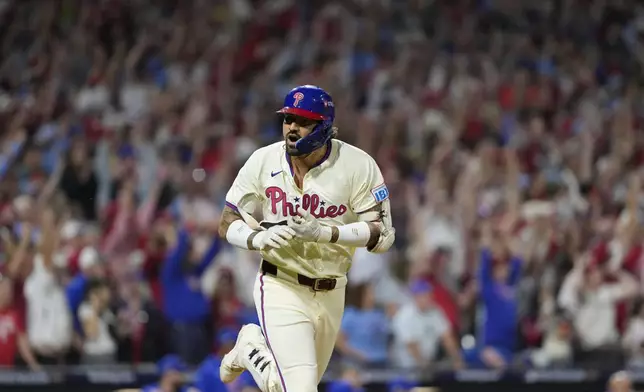 Philadelphia Phillies' Nick Castellanos reacts after hitting a one-run single against New York Mets pitcher Tylor Megill during the ninth inning to win Game 2 of a baseball NL Division Series, Sunday, Oct. 6, 2024, in Philadelphia. (AP Photo/Matt Slocum)