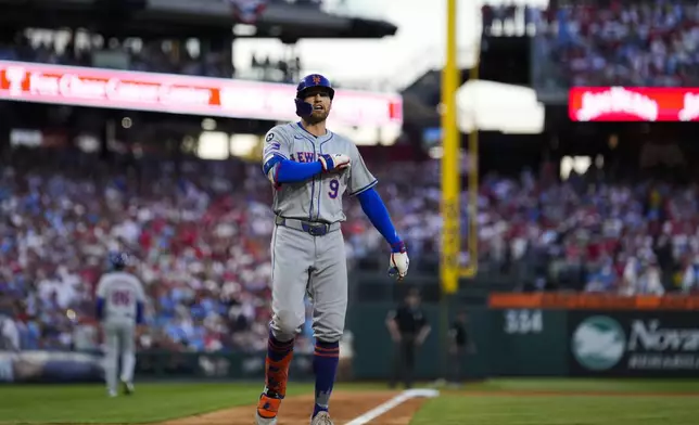 New York Mets' Brandon Nimmo reacts after hitting a home run against Philadelphia Phillies pitcher Orion Kerkering during the seventh inning of Game 2 of a baseball NL Division Series, Sunday, Oct. 6, 2024, in Philadelphia. (AP Photo/Matt Slocum)