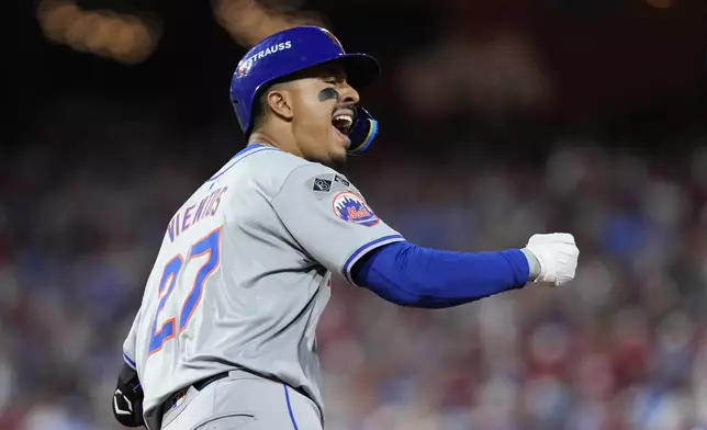 New York Mets' Mark Vientos reacts after hitting a two-run home run against Philadelphia Phillies pitcher Matt Strahm during the ninth inning of Game 2 of a baseball NL Division Series, Sunday, Oct. 6, 2024, in Philadelphia. (AP Photo/Matt Slocum)