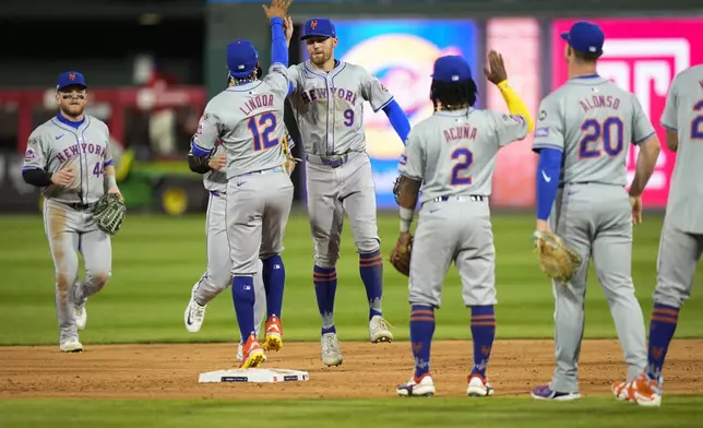 The New York Mets celebrate after winning Game 1 of a baseball NL Division Series against the Philadelphia Phillies, Saturday, Oct. 5, 2024, in Philadelphia. (AP Photo/Chris Szagola)