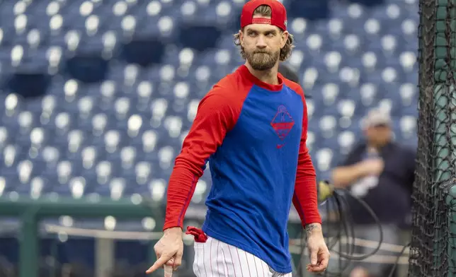 Philadelphia Phillies' Bryce Harper looks on during a baseball workout in Philadelphia, Friday, Oct. 4, 2024, ahead of the National League Division Series against the New York Mets. (AP Photo/Chris Szagola)