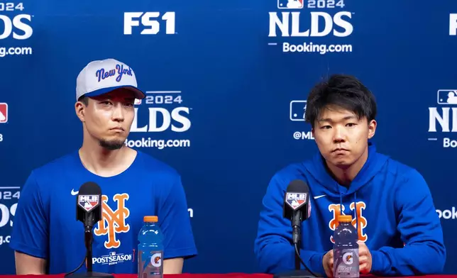 New York Mets' Kodai Senga, left, speaks alongside his interpreter Hiro Fujiwara, right, during a baseball news conference, Friday, Oct. 4, 2024, in Philadelphia, ahead of the National League Division Series against the Philadelphia Phillies. (AP Photo/Chris Szagola)