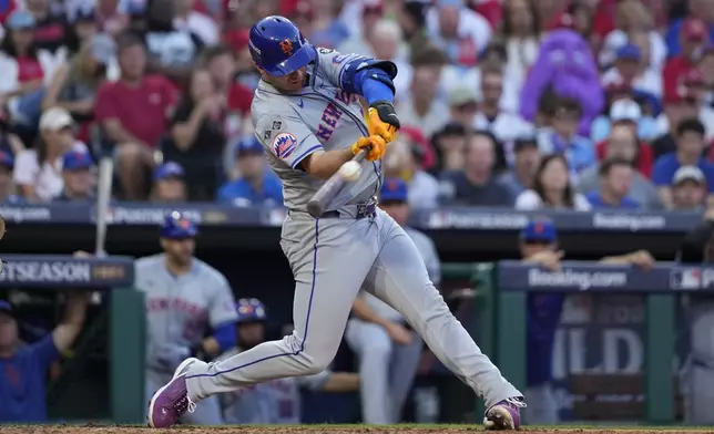 New York Mets' Pete Alonso hits a home run against Philadelphia Phillies pitcher José Ruiz during the sixth inning of Game 2 of a baseball NL Division Series, Sunday, Oct. 6, 2024, in Philadelphia. (AP Photo/Matt Slocum)