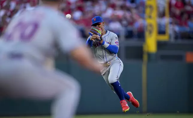 New York Mets shortstop Francisco Lindor throws to first on a ground out by Philadelphia Phillies' Johan Rojas during the third inning of Game 1 of a baseball NL Division Series, Saturday, Oct. 5, 2024, in Philadelphia. (AP Photo/Matt Slocum)