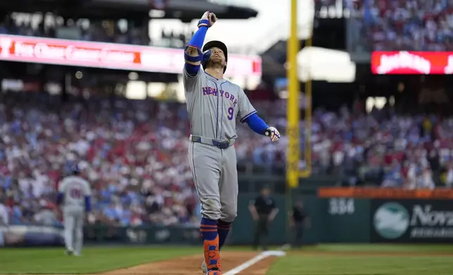 New York Mets' Brandon Nimmo reacts after hitting a home run against Philadelphia Phillies pitcher Orion Kerkering during the seventh inning of Game 2 of a baseball NL Division Series, Sunday, Oct. 6, 2024, in Philadelphia. (AP Photo/Matt Slocum)