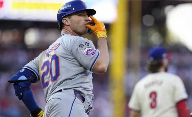 New York Mets' Pete Alonso reacts after hitting a home run against Philadelphia Phillies pitcher José Ruiz during the sixth inning of Game 2 of a baseball NL Division Series, Sunday, Oct. 6, 2024, in Philadelphia. (AP Photo/Matt Slocum)