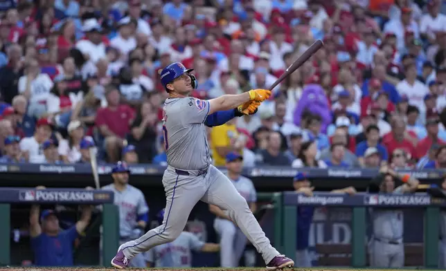 New York Mets' Pete Alonso follows through after hitting a home run against Philadelphia Phillies pitcher José Ruiz during the sixth inning of Game 2 of a baseball NL Division Series, Sunday, Oct. 6, 2024, in Philadelphia. (AP Photo/Matt Slocum)