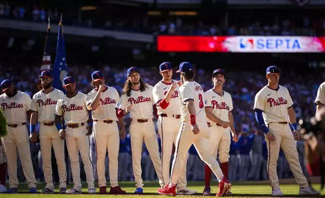 Philadelphia Phillies' Bryce Harper (3) greets teammates after he was announced ahead of Game 1 of a baseball NL Division Series against the New York Mets, Saturday, Oct. 5, 2024, in Philadelphia. (AP Photo/Matt Slocum)