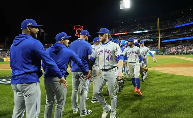 New York Mets' Harrison Bader (44) celebrates with teammates after they won Game 1 of a baseball NL Division Series against the Philadelphia Phillies, Saturday, Oct. 5, 2024, in Philadelphia. (AP Photo/Chris Szagola)