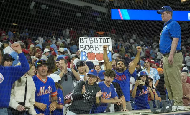 New York Mets fans celebrate after the Mets won Game 1 of a baseball NL Division Series against the Philadelphia Phillies, Saturday, Oct. 5, 2024, in Philadelphia. (AP Photo/Chris Szagola)