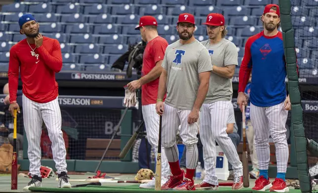 Philadelphia Phillies gather during a baseball workout in Philadelphia, Friday, Oct. 4, 2024, ahead of the National League Division Series against the New York Mets. (AP Photo/Chris Szagola)