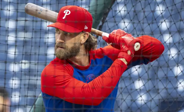 Philadelphia Phillies' Bryce Harper gets into the batting cage during a baseball workout in Philadelphia, Friday, Oct. 4, 2024, ahead of the National League Division Series against the New York Mets. (AP Photo/Chris Szagola)