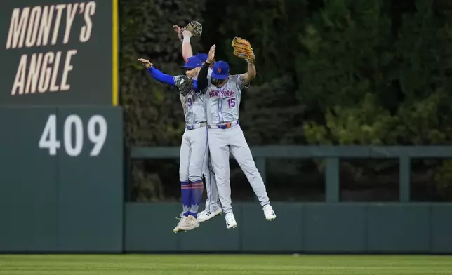 New York Mets' Brandon Nimmo (9) and Tyrone Taylor (15) celebrate after winning Game 1 of a baseball NL Division Series against the Philadelphia Phillies, Saturday, Oct. 5, 2024, in Philadelphia. (AP Photo/Matt Slocum)