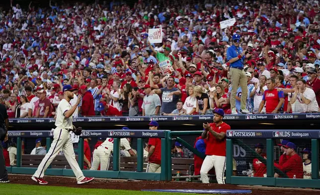 Philadelphia Phillies pitcher Zack Wheeler acknowledges fans after the seventh inning of Game 1 of a baseball NL Division Series against the New York Mets, Saturday, Oct. 5, 2024, in Philadelphia. (AP Photo/Chris Szagola)