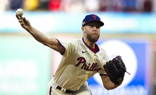 Philadelphia Phillies' Zack Wheeler pitches during the fifth inning of Game 1 of a baseball NL Division Series against the New York Mets, Saturday, Oct. 5, 2024, in Philadelphia. (AP Photo/Chris Szagola)