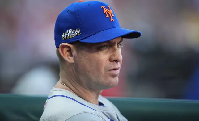 New York Mets manager Carlos Mendoza looks on during the third inning of Game 1 of a baseball NL Division Series against the Philadelphia Phillies, Saturday, Oct. 5, 2024, in Philadelphia. (AP Photo/Chris Szagola)