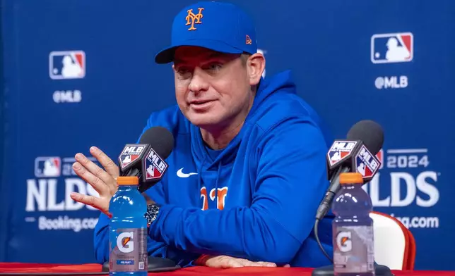 New York Mets manager Carlos Mendoza speaks during a baseball news conference, Friday, Oct. 4, 2024, in Philadelphia, ahead of the National League Division Series against the Philadelphia Phillies. (AP Photo/Chris Szagola)