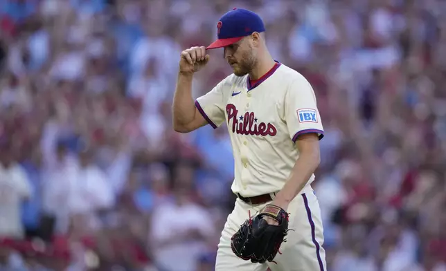 Philadelphia Phillies pitcher Zack Wheeler reacts after New York Mets' Jose Iglesias hit into a double play during the fourth inning of Game 1 of a baseball NL Division Series, Saturday, Oct. 5, 2024, in Philadelphia. (AP Photo/Matt Slocum)