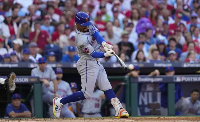 New York Mets' Francisco Lindor hits a single against Philadelphia Phillies pitcher Cristopher Sánchez during the third inning of Game 2 of a baseball NL Division Series, Sunday, Oct. 6, 2024, in Philadelphia. (AP Photo/Matt Slocum)