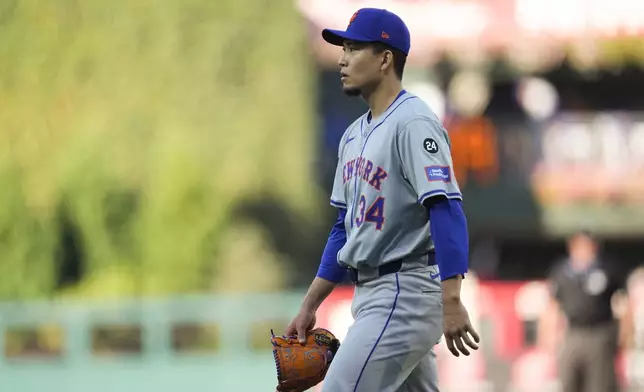 New York Mets pitcher Kodai Senga walks to the dugout during the second inning of Game 1 of a baseball NL Division Series against the Philadelphia Phillies, Saturday, Oct. 5, 2024, in Philadelphia. (AP Photo/Chris Szagola)