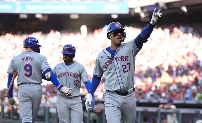 New York Mets' Mark Vientos celebrates after hitting a two-run home run against Philadelphia Phillies pitcher Cristopher Sánchez during the third inning of Game 2 of a baseball NL Division Series, Sunday, Oct. 6, 2024, in Philadelphia. (AP Photo/Chris Szagola)