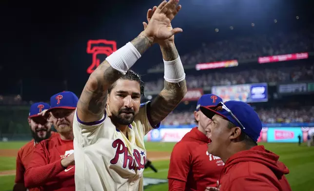 Philadelphia Phillies' Nick Castellanos celebrates after the Phillies won Game 2 of a baseball NL Division Series against the New York Mets, Sunday, Oct. 6, 2024, in Philadelphia. (AP Photo/Matt Slocum)