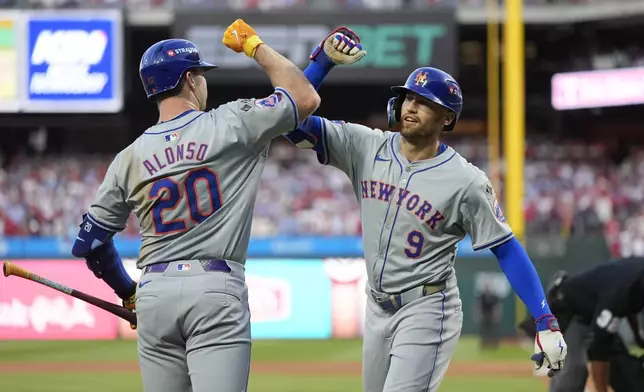 New York Mets' Brandon Nimmo (9) celebrates with Pete Alonso after hitting a home run against Philadelphia Phillies pitcher Orion Kerkering during the seventh inning of Game 2 of a baseball NL Division Series, Sunday, Oct. 6, 2024, in Philadelphia. (AP Photo/Chris Szagola)