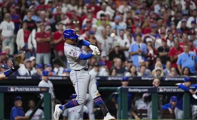 New York Mets' Mark Vientos hits a two-run home run against Philadelphia Phillies pitcher Matt Strahm during the ninth inning of Game 2 of a baseball NL Division Series, Sunday, Oct. 6, 2024, in Philadelphia. (AP Photo/Matt Slocum)