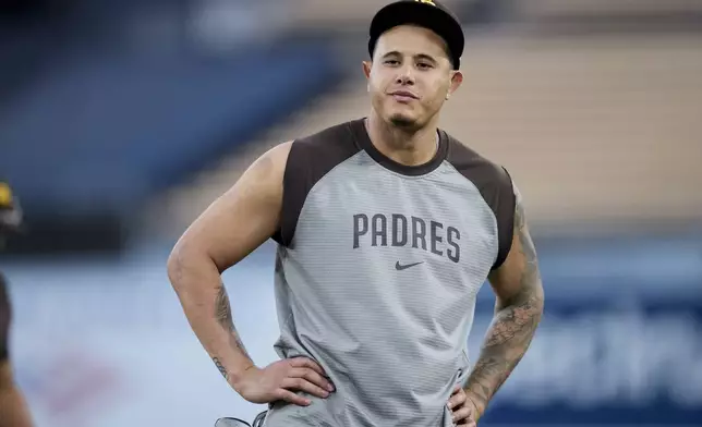 San Diego Padres' Manny Machado stands on the field during practice ahead of Game 5 of a baseball National League Division Series against the Los Angeles Dodgers, Thursday, Oct. 10, 2024, in Los Angeles. (AP Photo/Ashley Landis)