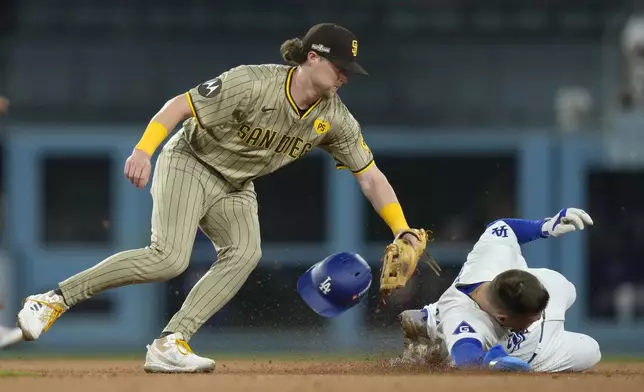 Los Angeles Dodgers' Freddie Freeman, right, steals second base against San Diego Padres second baseman Jake Cronenworth, left, during the third inning in Game 1 of baseball's NL Division Series Saturday, Oct. 5, 2024, in Los Angeles. (AP Photo/Mark J. Terrill)