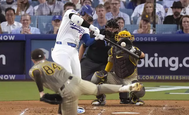 Los Angeles Dodgers' Shohei Ohtani, middle left, connects for a three-run home run off San Diego Padres starting pitcher Dylan Cease (84) during the second inning in Game 1 of baseball's NL Division Series, Saturday, Oct. 5, 2024, in Los Angeles. (AP Photo/Mark J. Terrill)