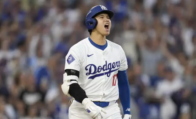 Los Angeles Dodgers' Shohei Ohtani reacts after hitting a three-run home run during the second inning in Game 1 of baseball's NL Division Series against the San Diego Padres, Saturday, Oct. 5, 2024, in Los Angeles. (AP Photo/Mark J. Terrill)