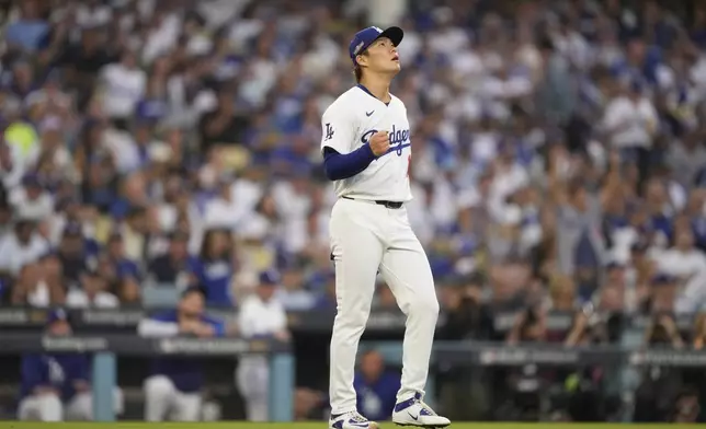 Los Angeles Dodgers starting pitcher Yoshinobu Yamamoto reacts as San Diego Padres' Jackson Merrill flies out during the fourth inning in Game 5 of a baseball NL Division Series Friday, Oct. 11, 2024, in Los Angeles. (AP Photo/Mark J. Terrill)