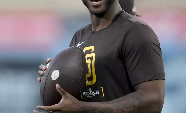 San Diego Padres' Jurickson Profar smiles during practice ahead of Game 5 of a baseball National League Division Series against the Los Angeles Dodgers, Thursday, Oct. 10, 2024, in Los Angeles. (AP Photo/Ashley Landis)