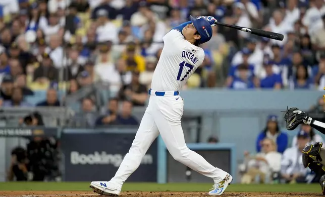 Los Angeles Dodgers' Shohei Ohtani pops out during the third inning in Game 5 of a baseball NL Division Series against the San Diego Padres, Friday, Oct. 11, 2024, in Los Angeles. (AP Photo/Ashley Landis)