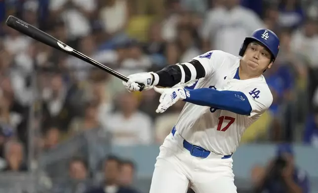 Los Angeles Dodgers' Shohei Ohtani strikes out during the sixth inning in Game 5 of a baseball NL Division Series against the San Diego Padres, Friday, Oct. 11, 2024, in Los Angeles. (AP Photo/Ashley Landis)