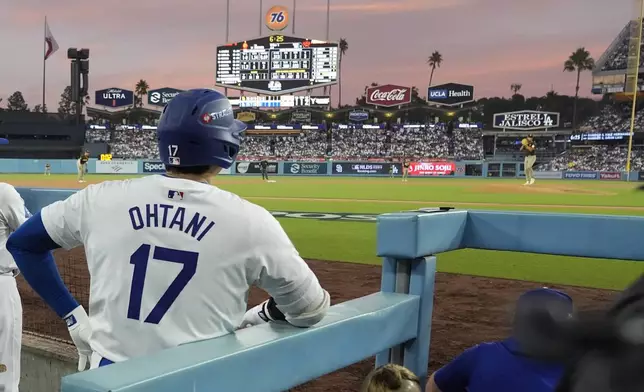 Los Angeles Dodgers' Shohei Ohtani (17) waits to bat as San Diego Padres starting pitcher Yu Darvish, right, throws during the fifth inning in Game 5 of a baseball NL Division Series against the San Diego Padres, Friday, Oct. 11, 2024, in Los Angeles. (AP Photo/Ashley Landis)